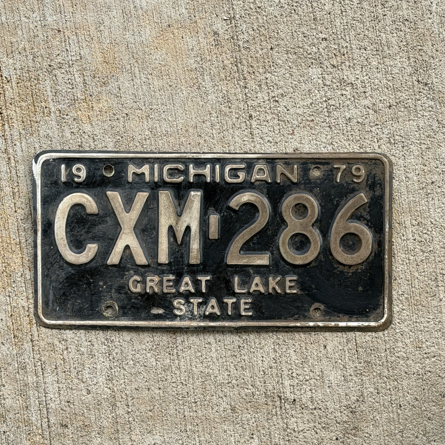 Photo of a 1979 Michigan License Plate Auto Tag Garage Decor Vintage CXM 286 with original patina