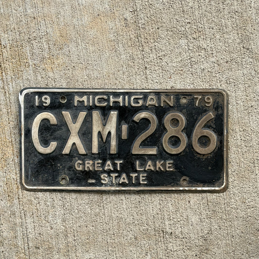 Photo of a 1979 Michigan License Plate Auto Tag Garage Decor Vintage CXM 286 with original patina
