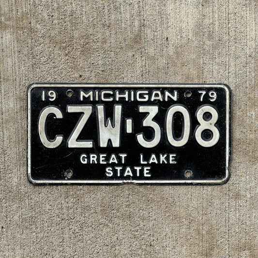 Photo of a 1979 Michigan License Plate Auto Tag Garage Decor Vintage CZW 308 with original patina