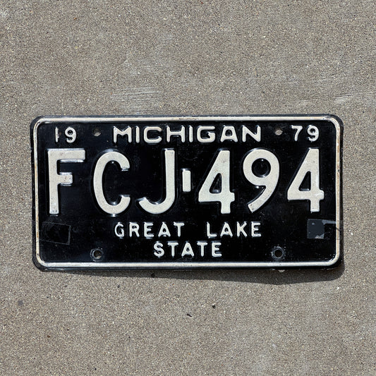 Photo of a 1979 Michigan License Plate Auto Tag Garage Decor Vintage FCJ 494 with original patina