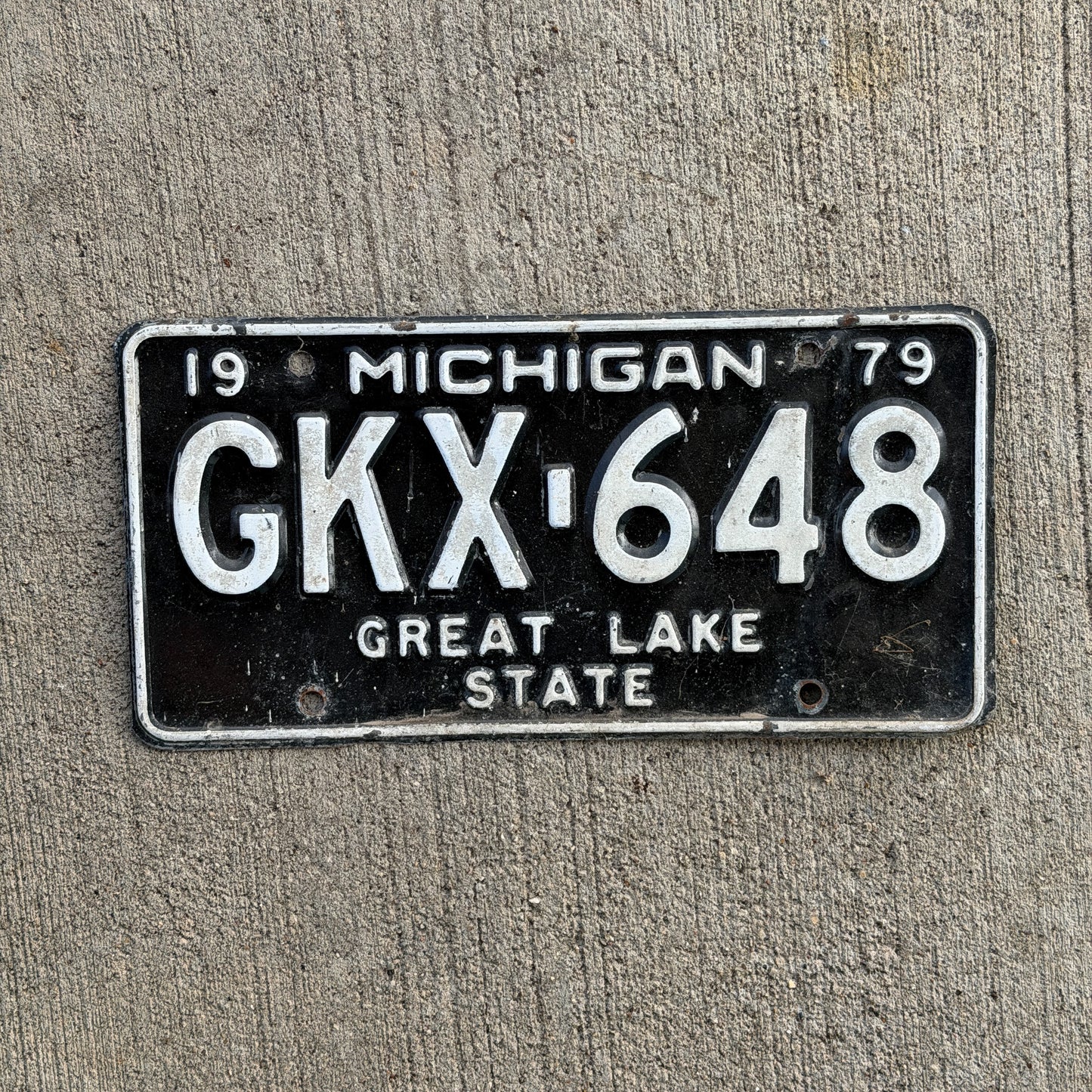 Photo of a 1979 Michigan License Plate Auto Tag Garage Decor Vintage GKX 648 with original patina