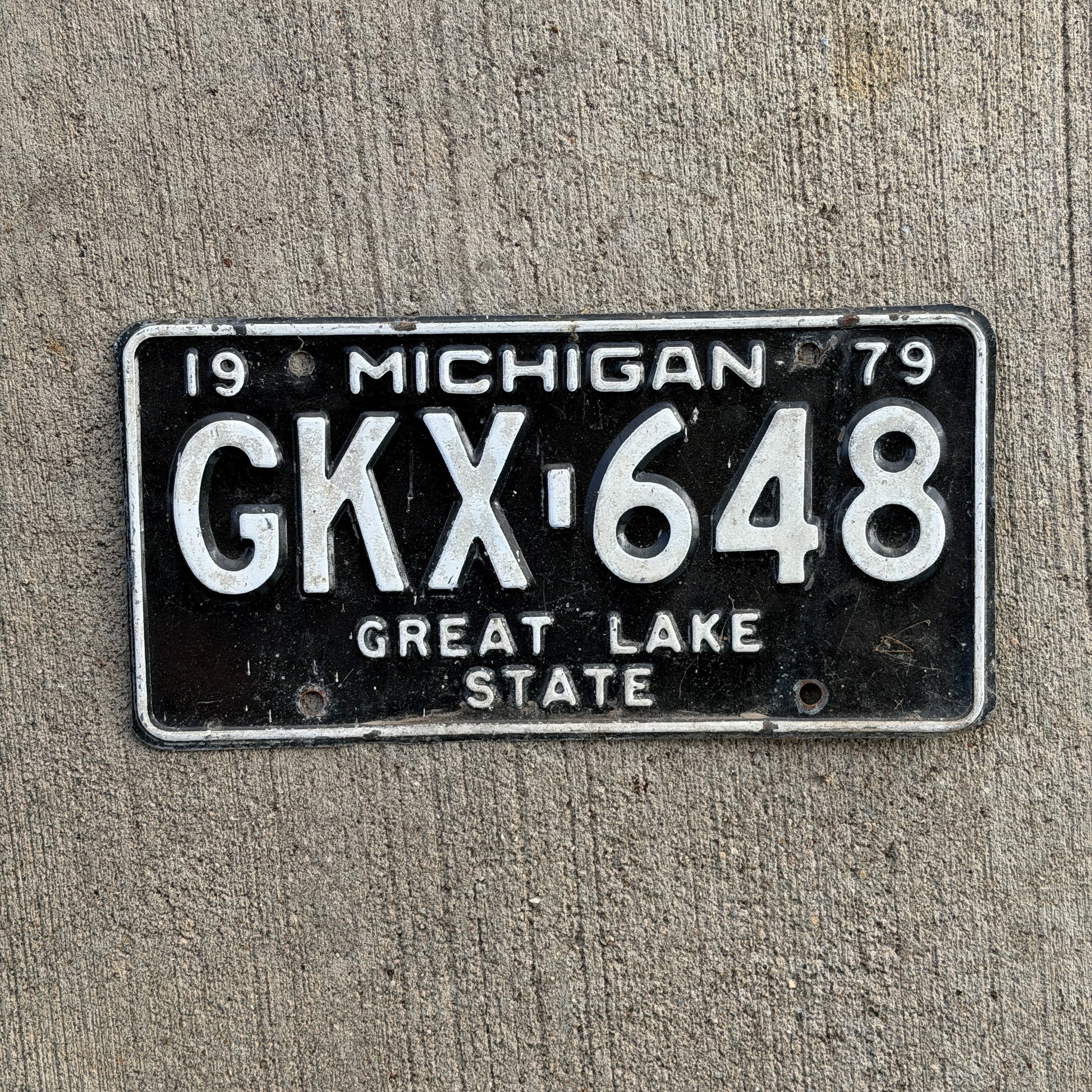 Photo of a 1979 Michigan License Plate Auto Tag Garage Decor Vintage GKX 648 with original patina