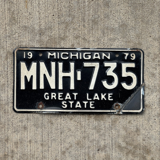 Photo of a 1979 Michigan License Plate Auto Tag Garage Decor Vintage MNH 735 with original patina