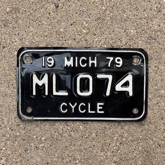 Photo of a 1979 Michigan Motorcycle License Plate Auto Tag Garage Decor Vintage ML 074 with original patina