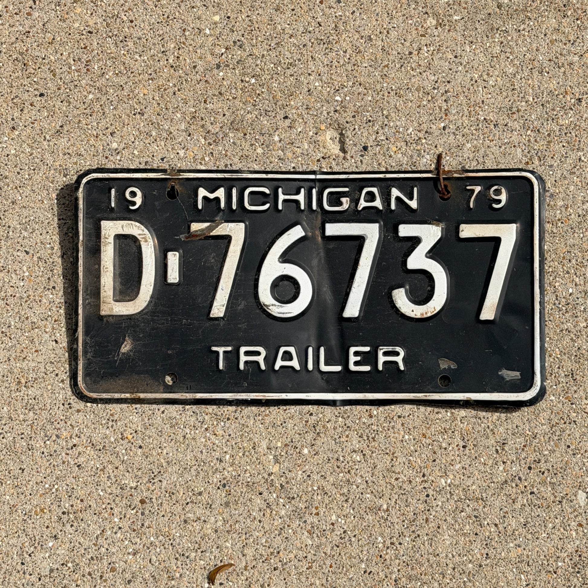 Photo of a 1979 Michigan Trailer License Plate Auto Tag Garage Decor Vintage D 76737 with original patina