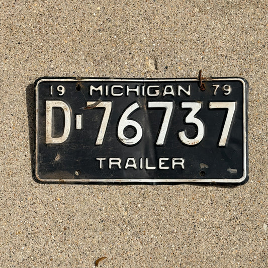 Photo of a 1979 Michigan Trailer License Plate Auto Tag Garage Decor Vintage D 76737 with original patina