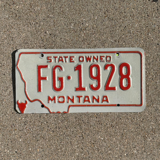 Photo of a 1979 Montana State Owned License Plate Auto Tag Garage Decor Vintage State Shape FG 1928 with original patina