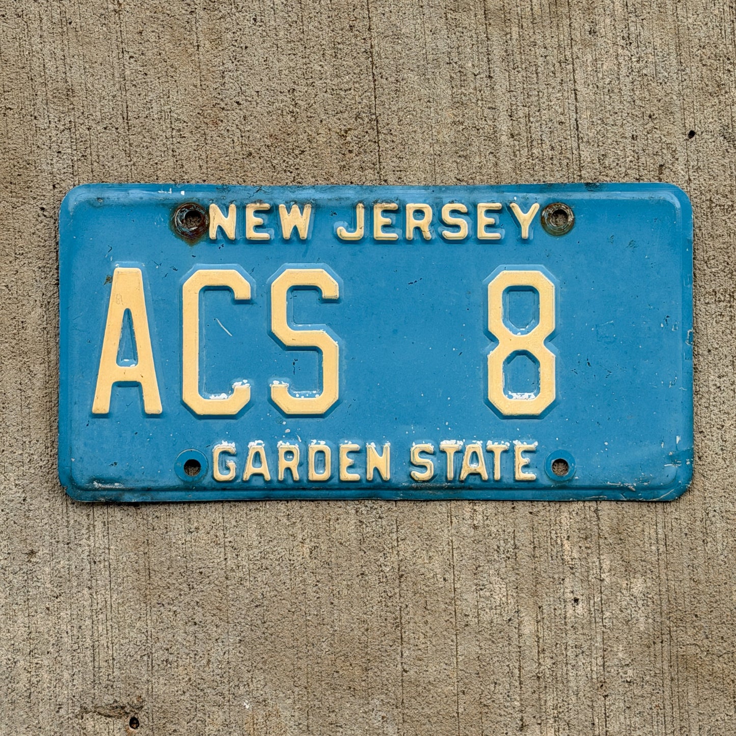 Photo of a 1979 New Jersey Courtesy License Plate Auto Tag Garage Decor Vintage Blue Atlantic County ACS 8 with original patina