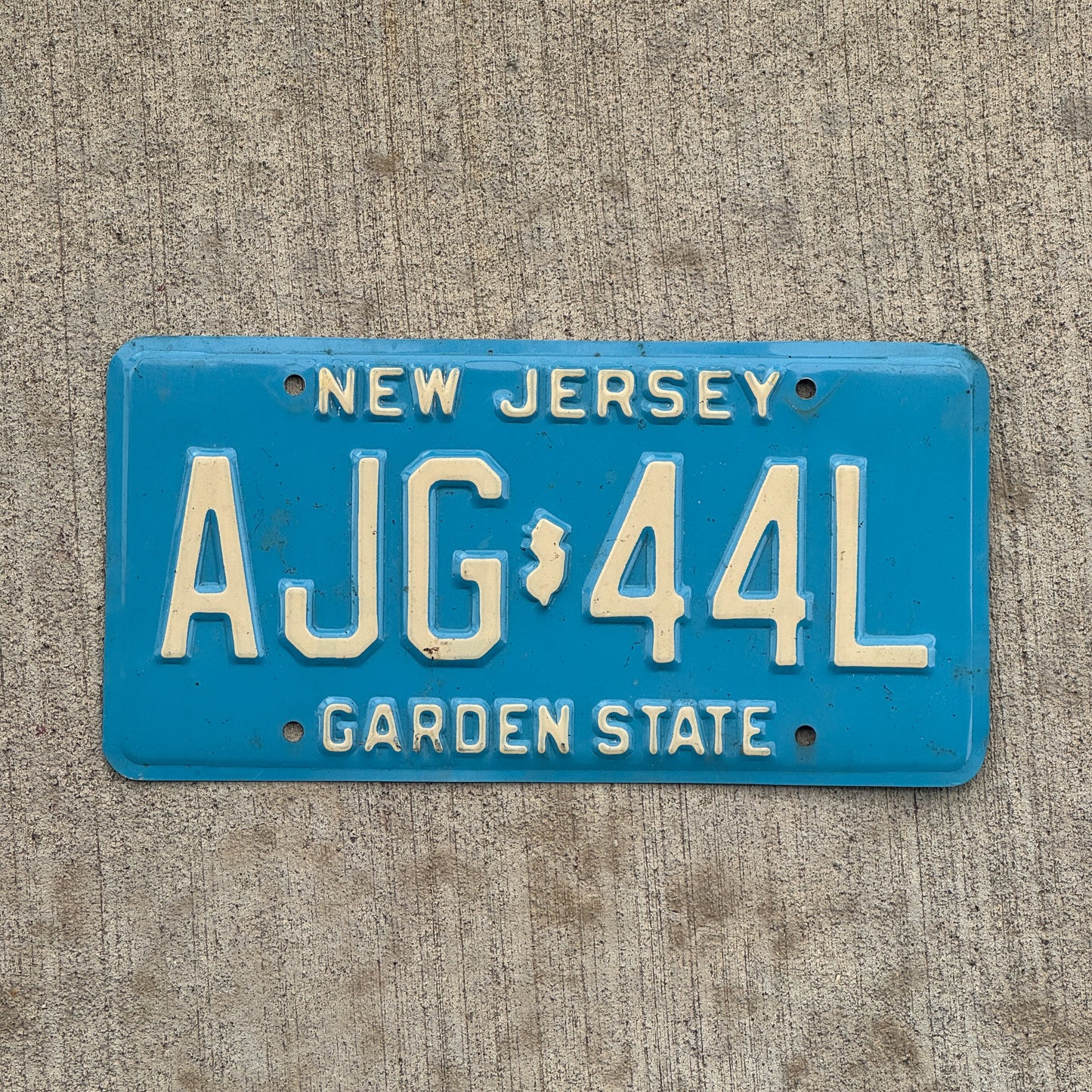 Photo of a 1979 New Jersey License Plate Auto Tag 1 Vintage Garage Blue AJG 44L with original patina