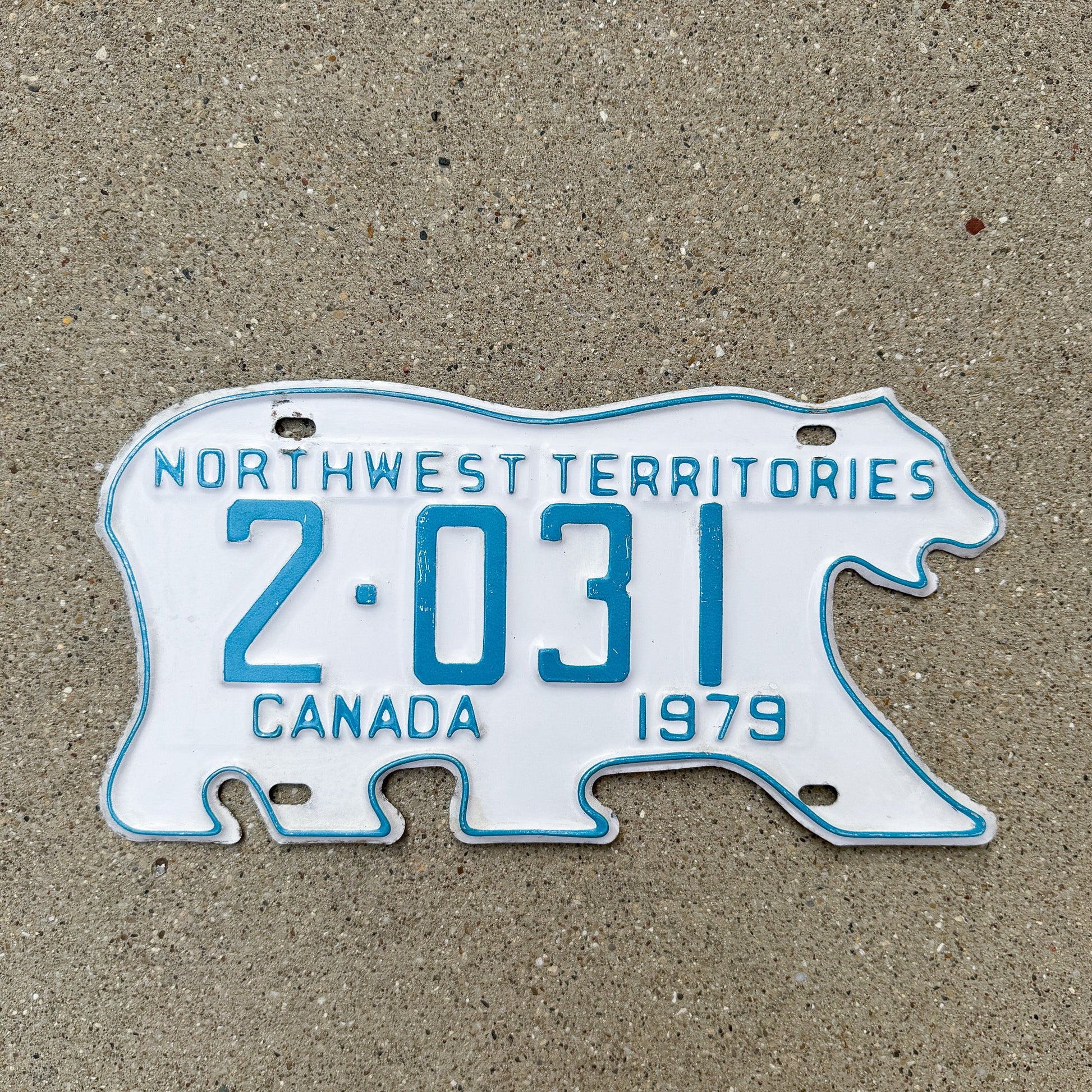 Photo of a 1979 Northwest Territories License Plate Auto Tag Garage Decor Vintage Low Number Four Digit Polar Bear 2 031 with original patina