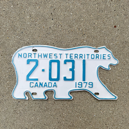 Photo of a 1979 Northwest Territories License Plate Auto Tag Garage Decor Vintage Low Number Four Digit Polar Bear 2 031 with original patina