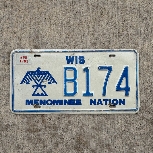 Photo of a 1980 1982 Wisconsin Graphic / Specialty License Plate Auto Tag Garage Decor Vintage Native American Indian Tribe Menominee Nation B 174 with original patina
