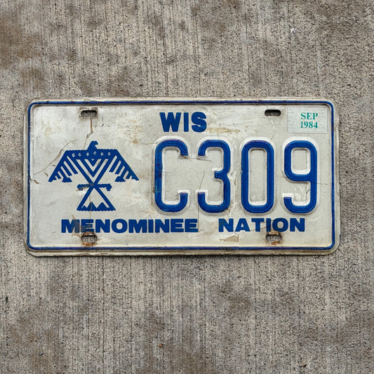 Photo of a 1980 1984 Wisconsin Graphic / Specialty License Plate Auto Tag Garage Decor Vintage Native American Indian Tribe Menominee Nation C 309 with original patina