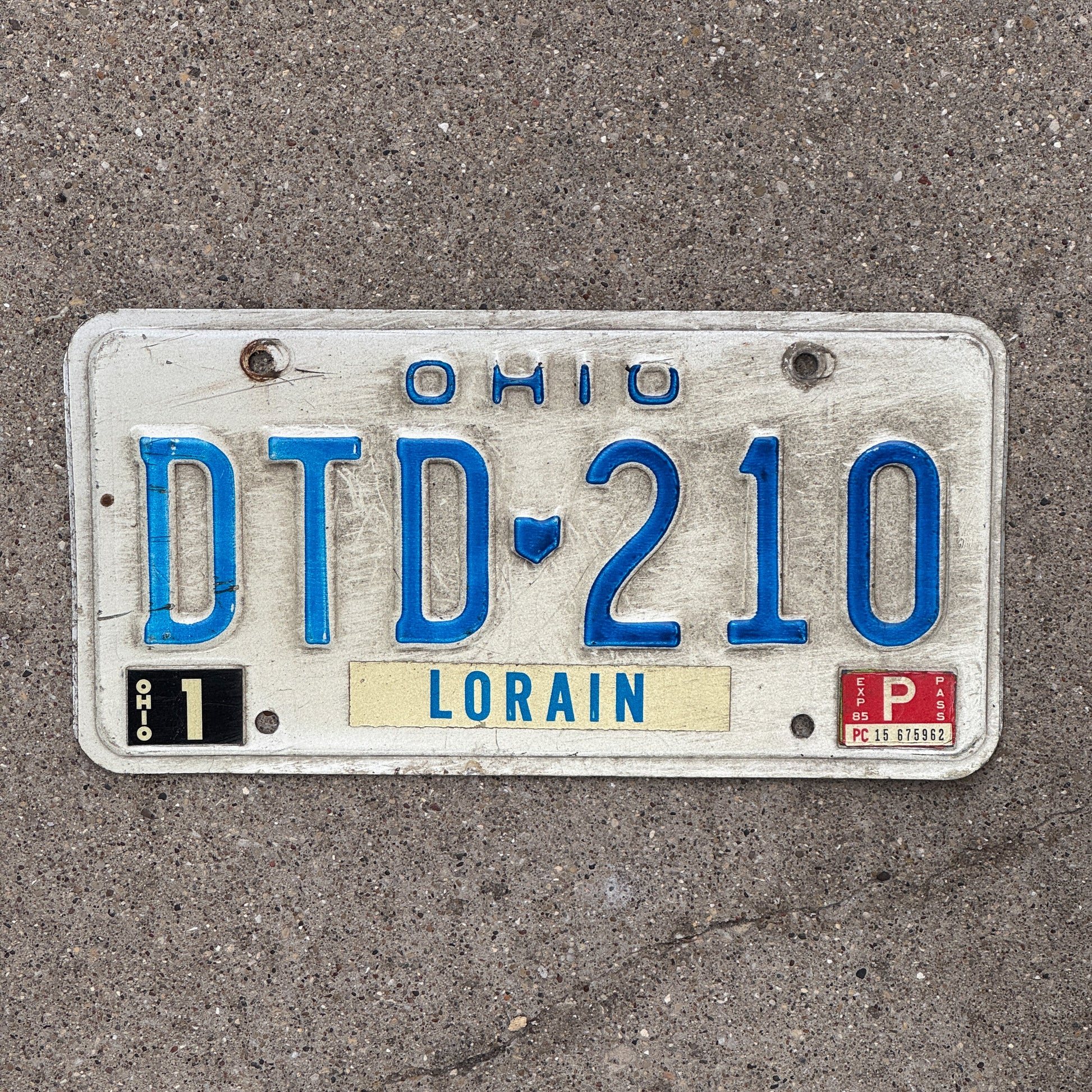 Photo of a 1980 1985 Ohio License Plate Auto Tag 1 Vintage Garage DTD 210 with original patina
