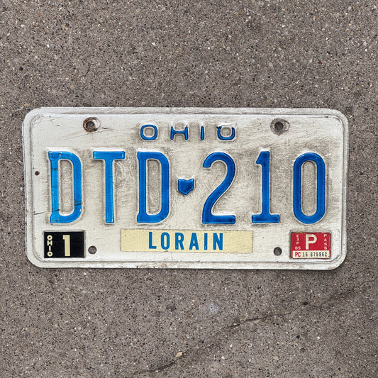 Photo of a 1980 1985 Ohio License Plate Auto Tag 1 Vintage Garage DTD 210 with original patina