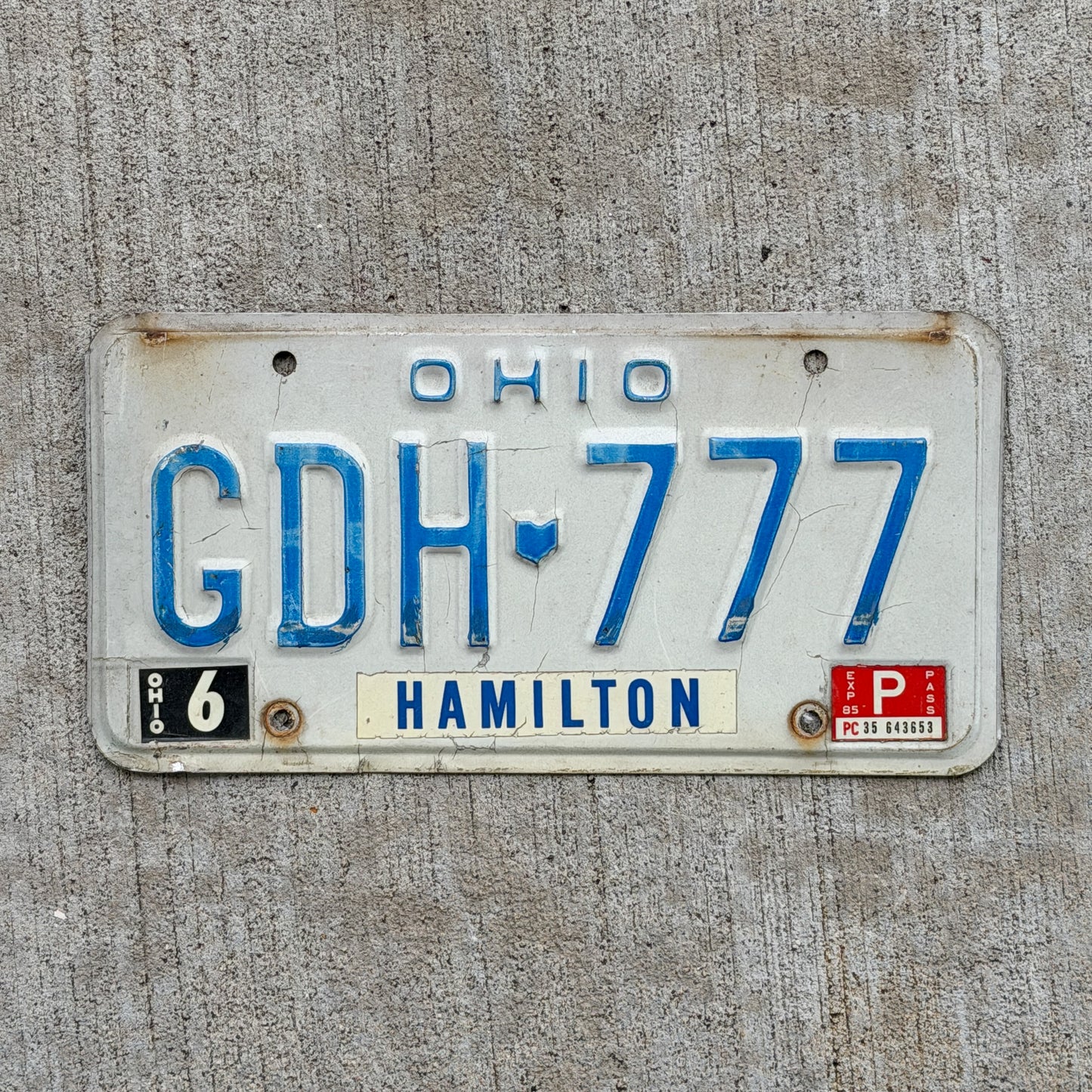 Photo of a 1980 1985 Ohio License Plate Auto Tag Garage Decor Vintage Lucky 7 Repeat Repeating GDH 777 with original patina