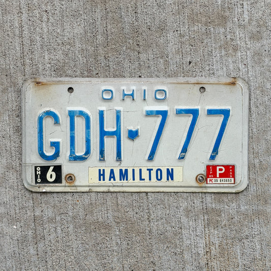 Photo of a 1980 1985 Ohio License Plate Auto Tag Garage Decor Vintage Lucky 7 Repeat Repeating GDH 777 with original patina