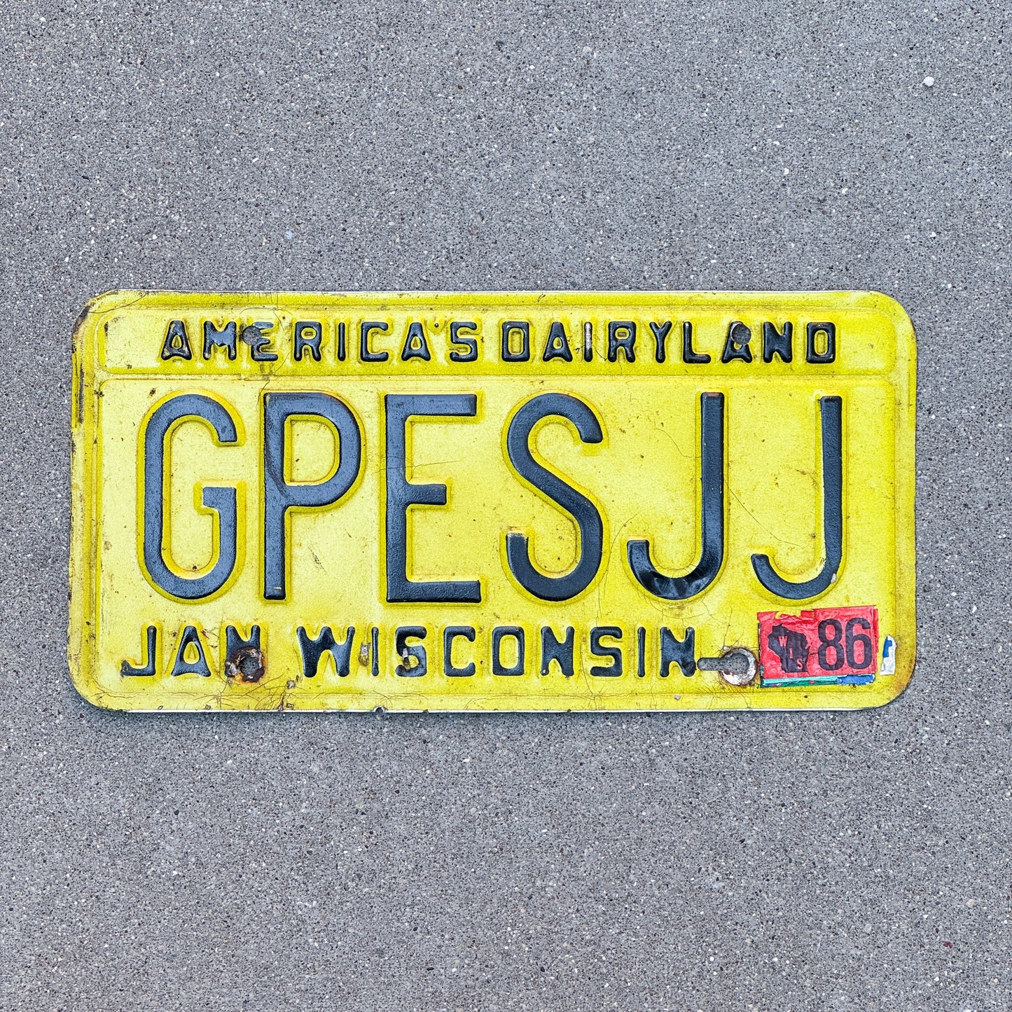 Photo of a 1980 1986 Wisconsin Vanity License Plate Auto Tag Garage Decor Vintage GPES JJ with original patina