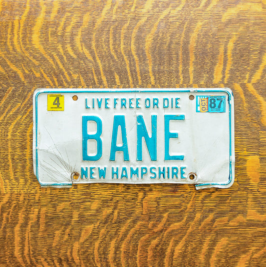 Photo of a 1980 1987 New Hampshire License Plate Auto Tag Garage Decor Vintage Super Villain Batman Comic BANE with original patina