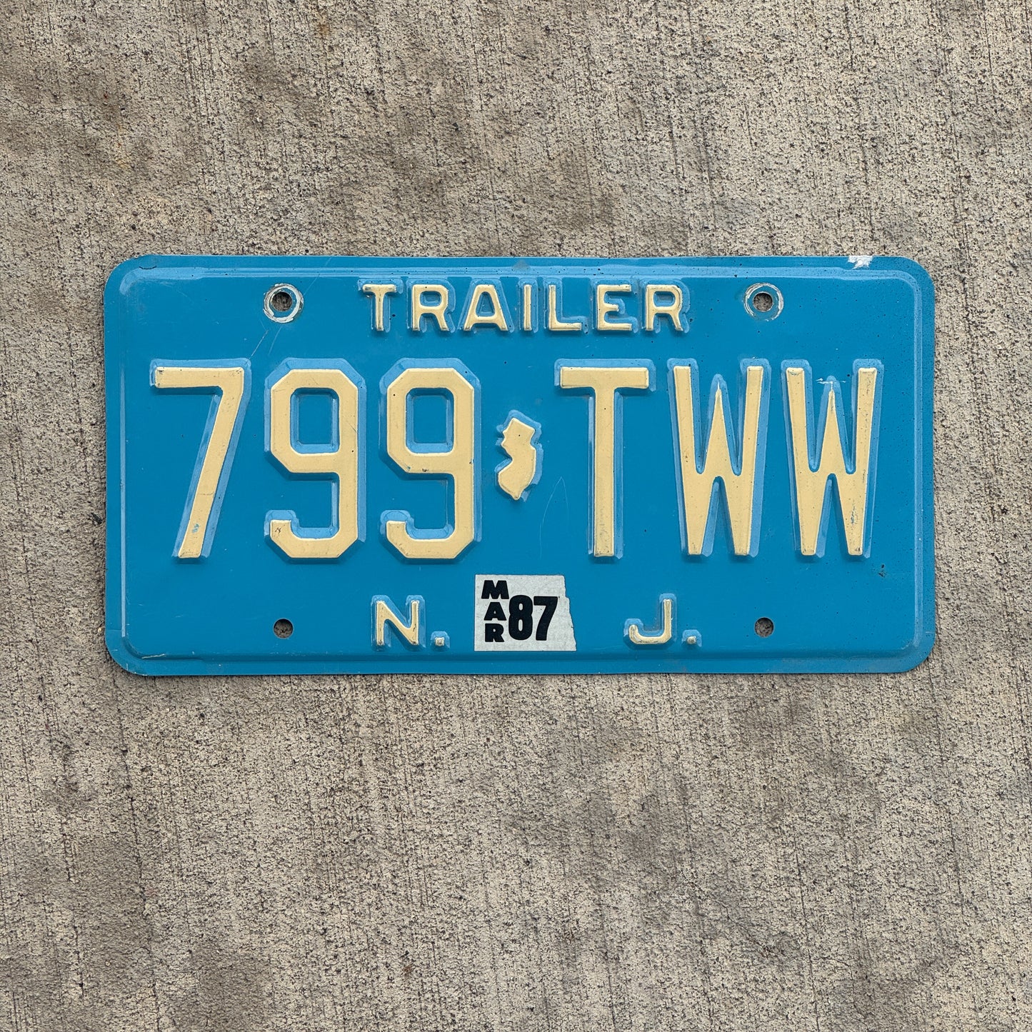 Photo of a 1980 1987 New Jersey Trailer License Plate Auto Tag Garage Decor Vintage Blue 799 TWW with original patina