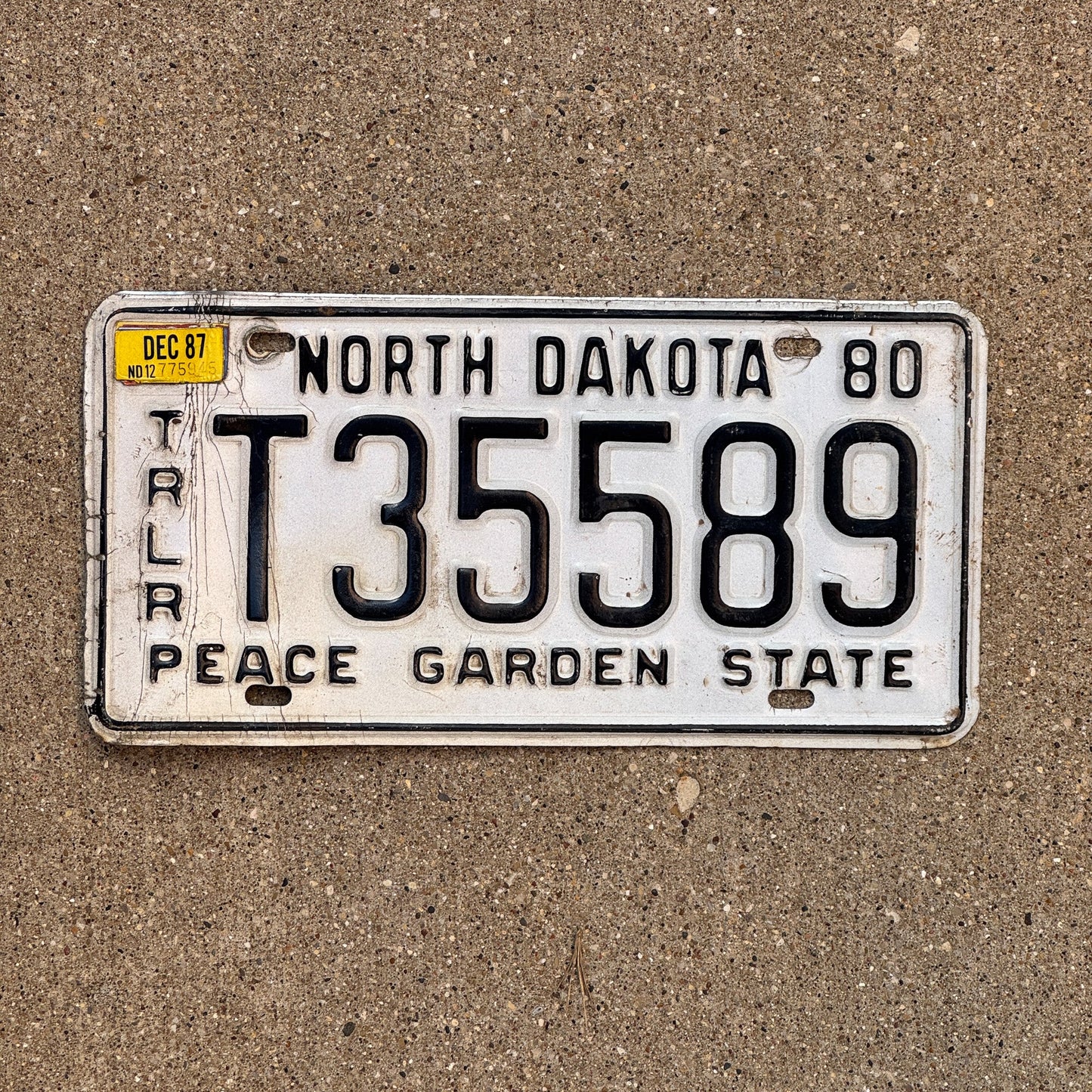 Photo of a 1980 1987 North Dakota Trailer License Plate Auto Tag Garage Decor Vintage T 35589 with original patina