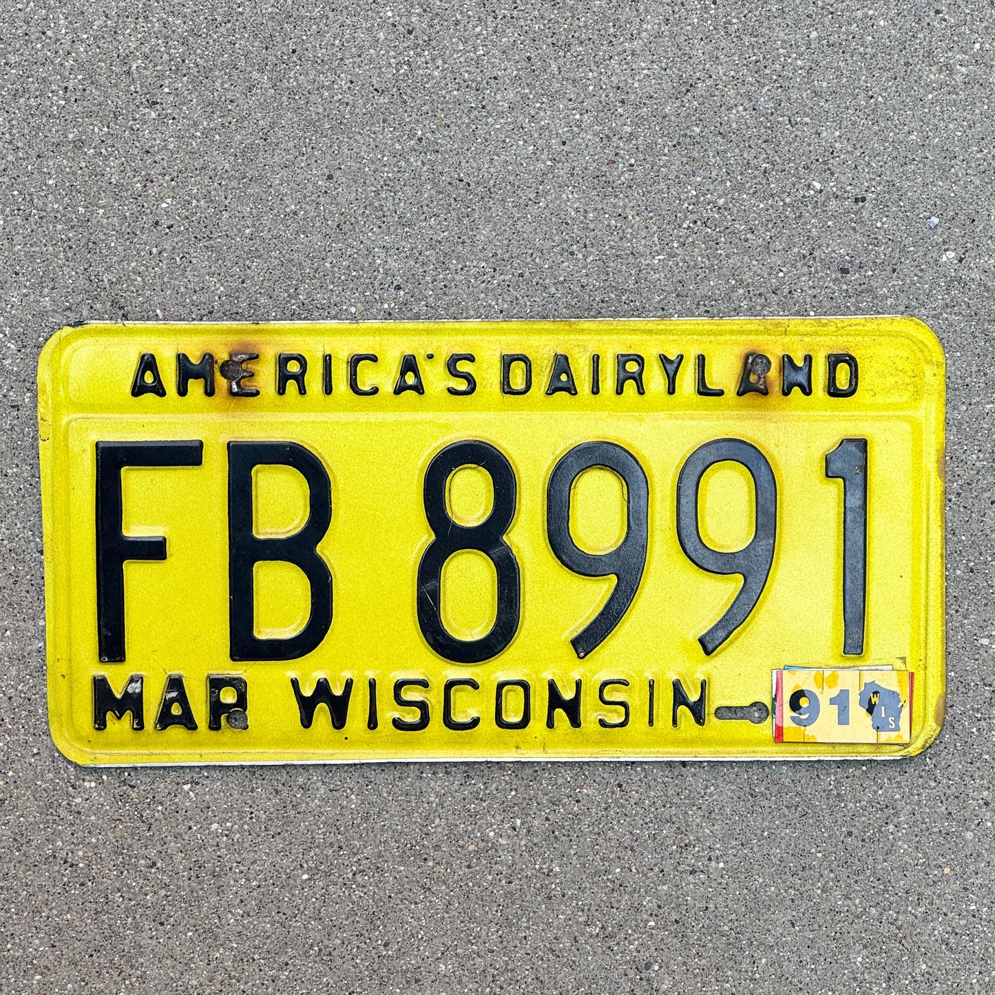 Photo of a 1980 1991 Wisconsin License Plate Auto Tag Garage Decor Vintage FB 8991 with original patina