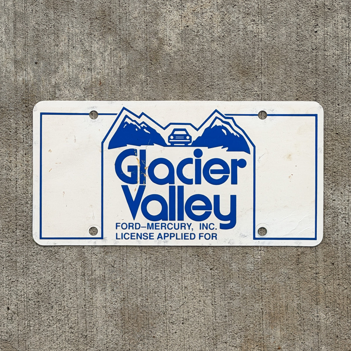 Photo of a 1980 Era Baraboo Wisconsin Booster License Plate Auto Tag Garage Decor Vintage Glacier Valley Ford Mercury Paper with original patina