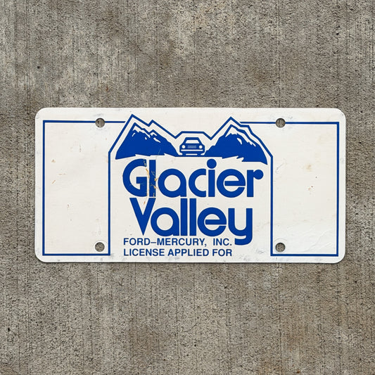 Photo of a 1980 Era Baraboo Wisconsin Booster License Plate Auto Tag Garage Decor Vintage Glacier Valley Ford Mercury Paper with original patina