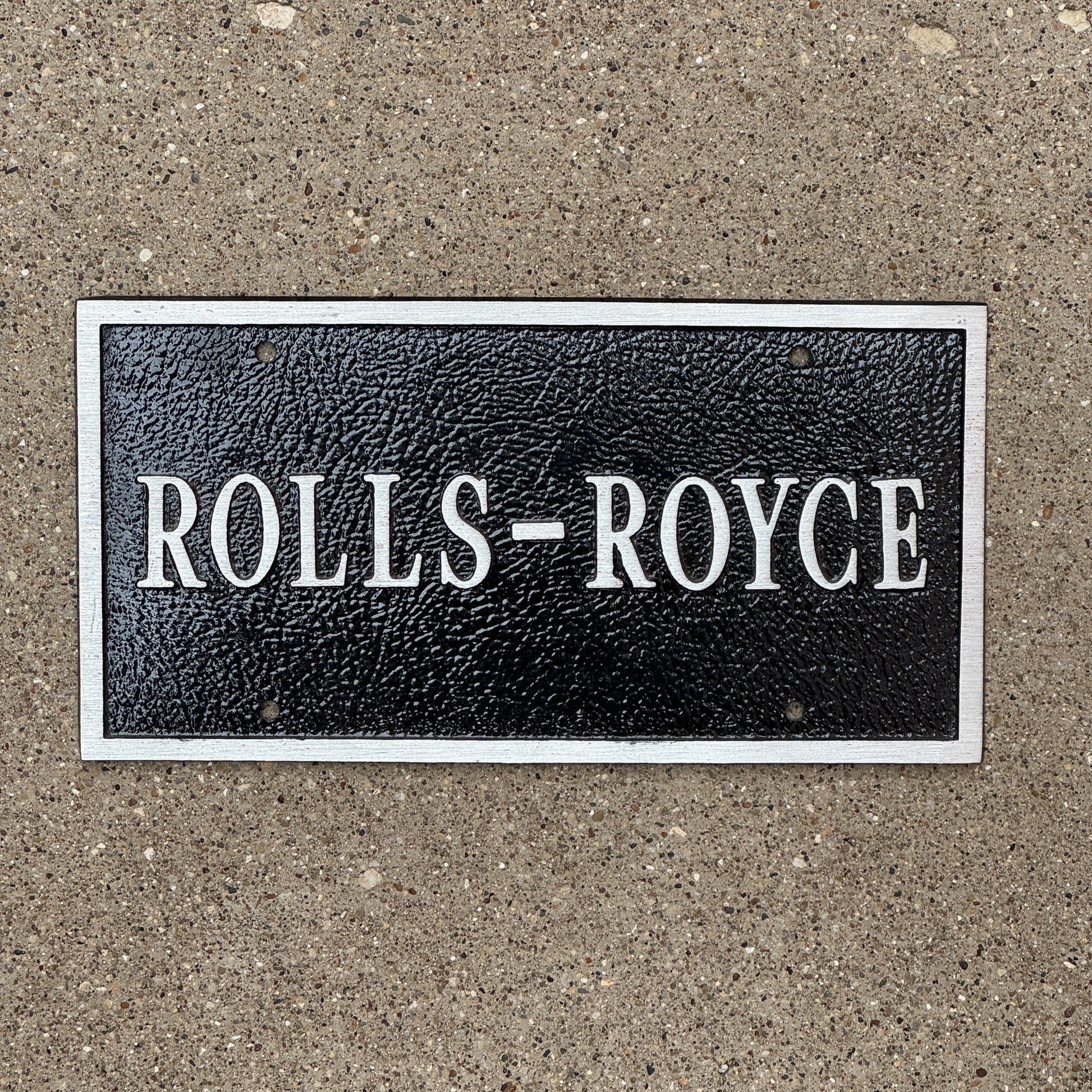 Photo of a 1980 Era Booster License Plate Auto Tag Garage Decor Vintage Car Make Model Heavy Cast Iron Rolls-Royce