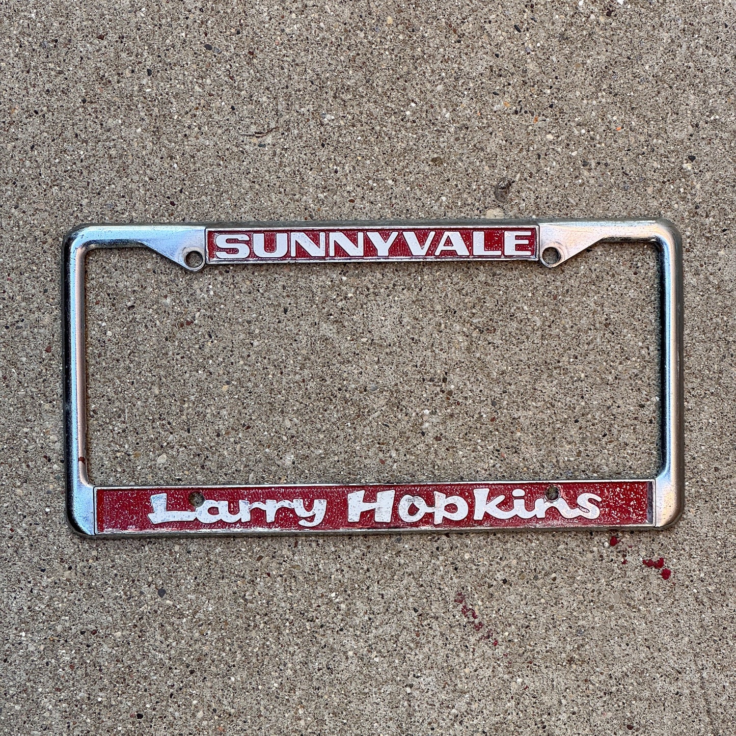 Photo of a 1980 Era California License Plate Frame Auto Tag Garage Decor Vintage Larry Hopkins Honda Dealer Sunnyvale Larry Hopkins with original patina