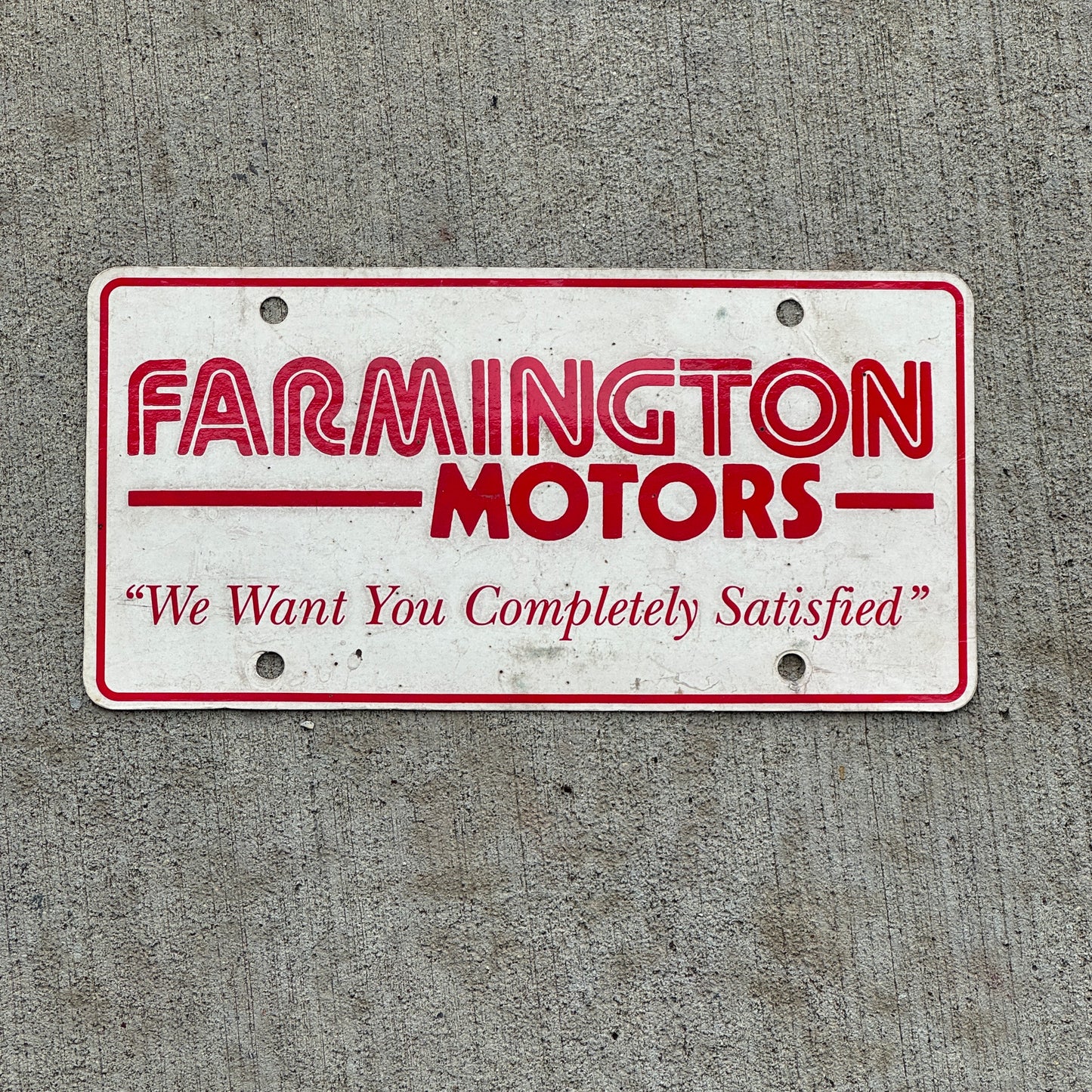 Photo of a 1980 Era Farmington Motors New Mexico Booster License Plate Auto Tag Garage Decor Vintage with original patina