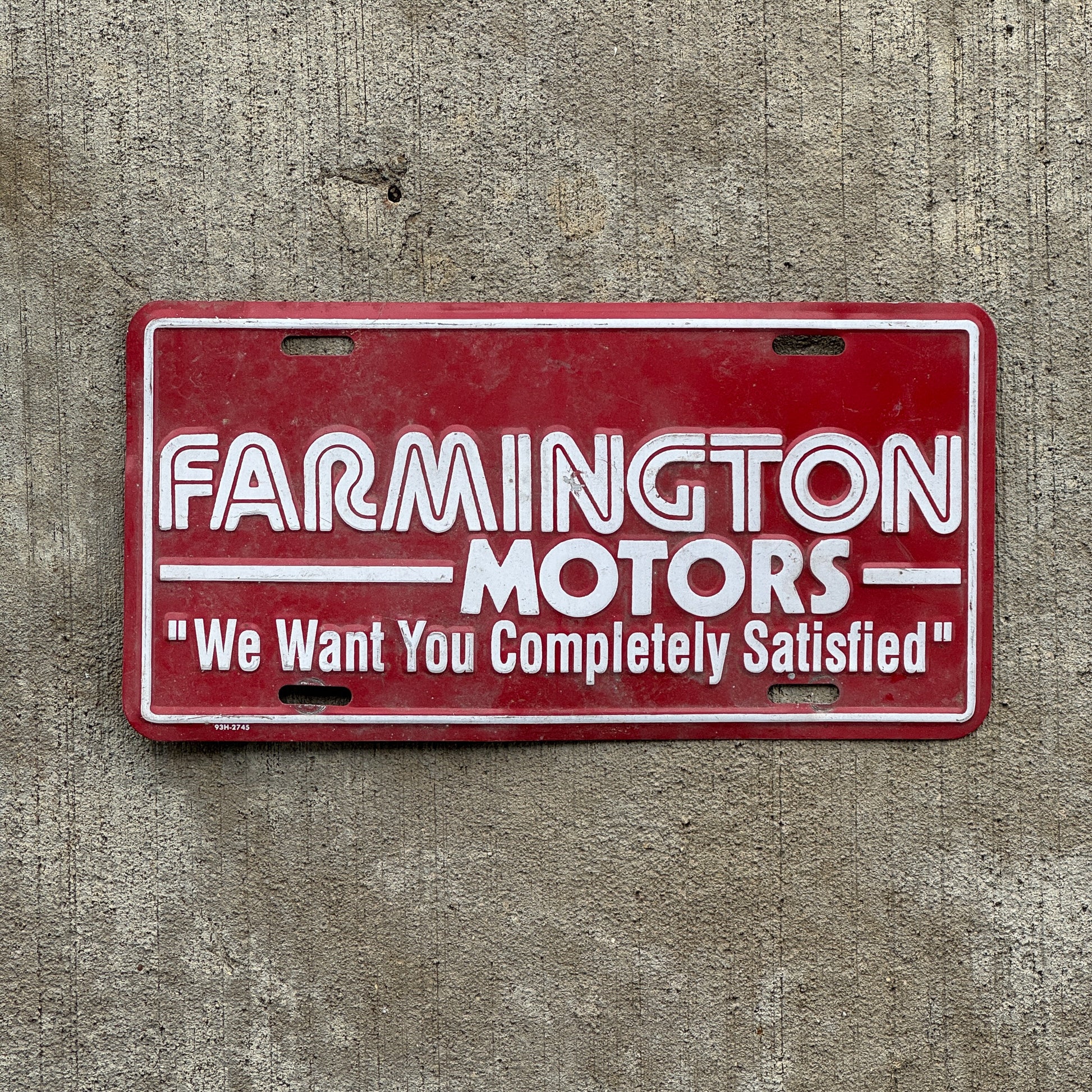 Photo of a 1980 Era Farmington Motors New Mexico Booster License Plate Auto Tag Garage Decor Vintage Metal with original patina