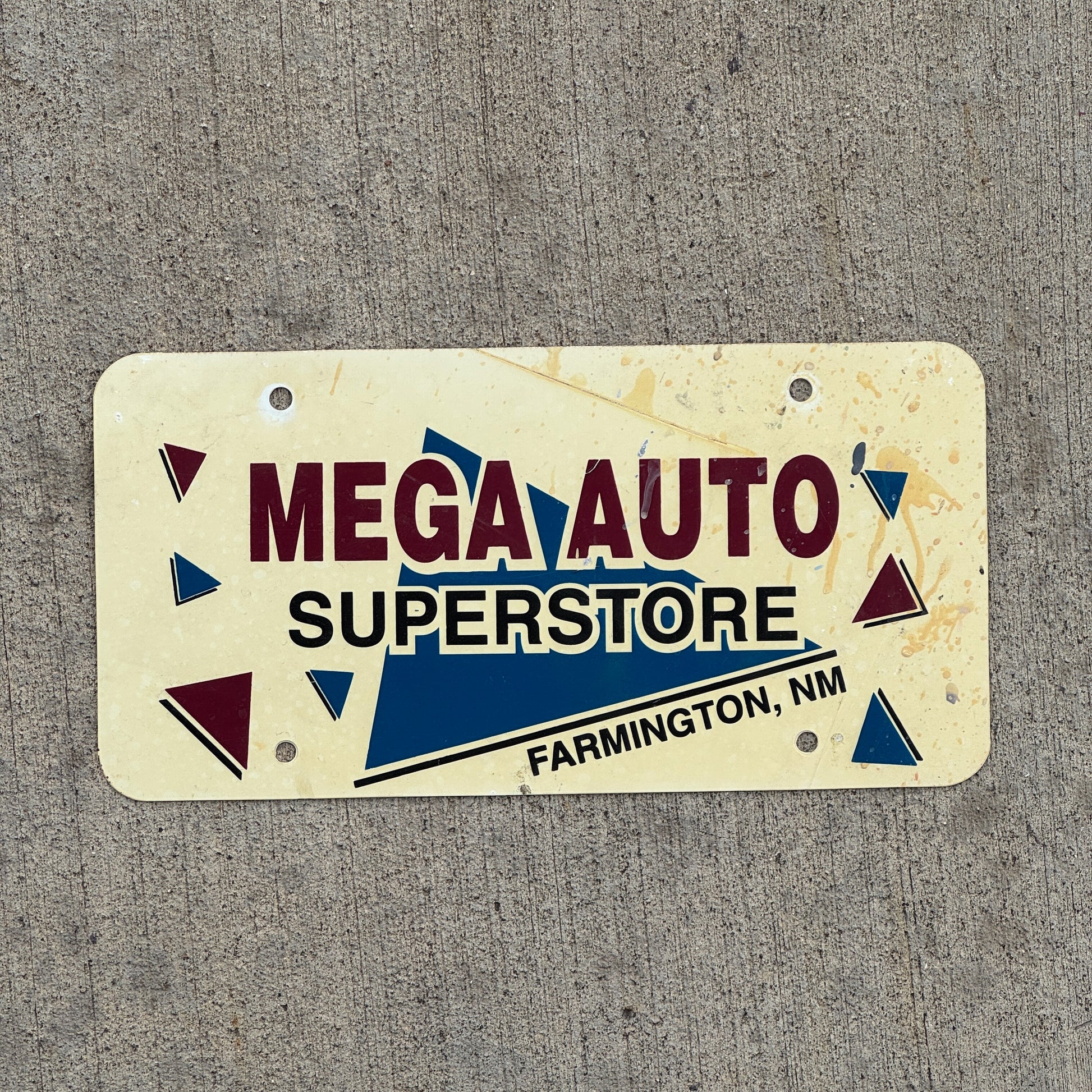 Photo of a 1980 Era Farmington New Mexico Booster License Plate Auto Tag Garage Decor Vintage Mega Auto Superstore Flimsy Plastic with original patina