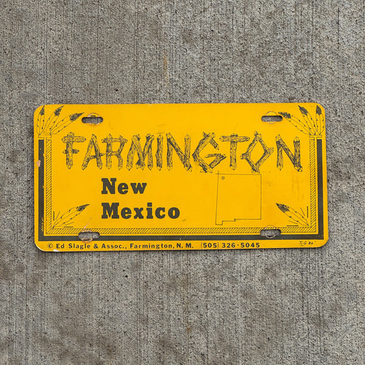 Photo of a 1980 Era Farmington New Mexico Booster License Plate Auto Tag Garage Decor Vintage Plastic with original patina