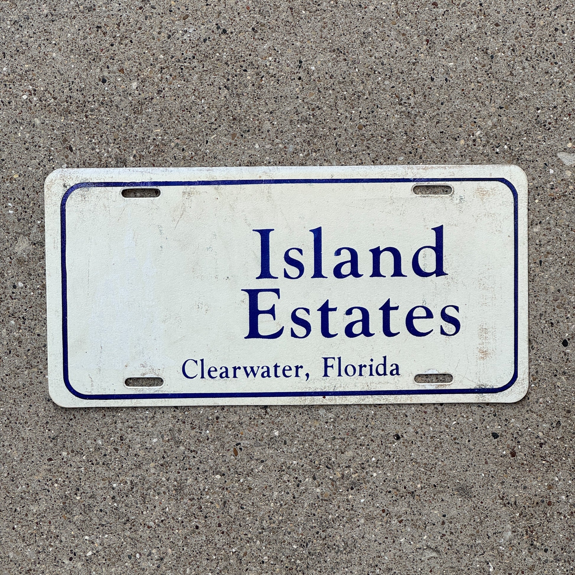 Photo of a 1980 Era Florida Booster License Plate Auto Tag Garage Decor Vintage Clearwater Plastic Island Estates with original patina