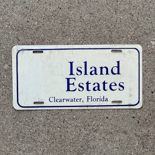 Photo of a 1980 Era Florida Booster License Plate Auto Tag Garage Decor Vintage Clearwater Plastic Island Estates with original patina
