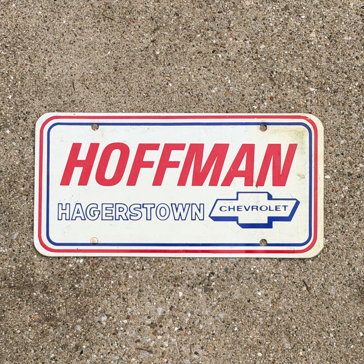 Photo of a 1980 Era Hagerstown Maryland Booster License Plate Auto Tag Garage Decor Vintage Hoffman Chevrolet Plastic with original patina