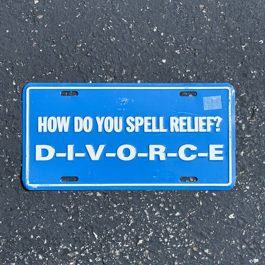 Photo of a 1980 Era How Do You Spell Relief? DIVORCE Booster License Plate Auto Tag Garage Decor Vintage
 Novelty Joke Gift Marriage Metal with original patina