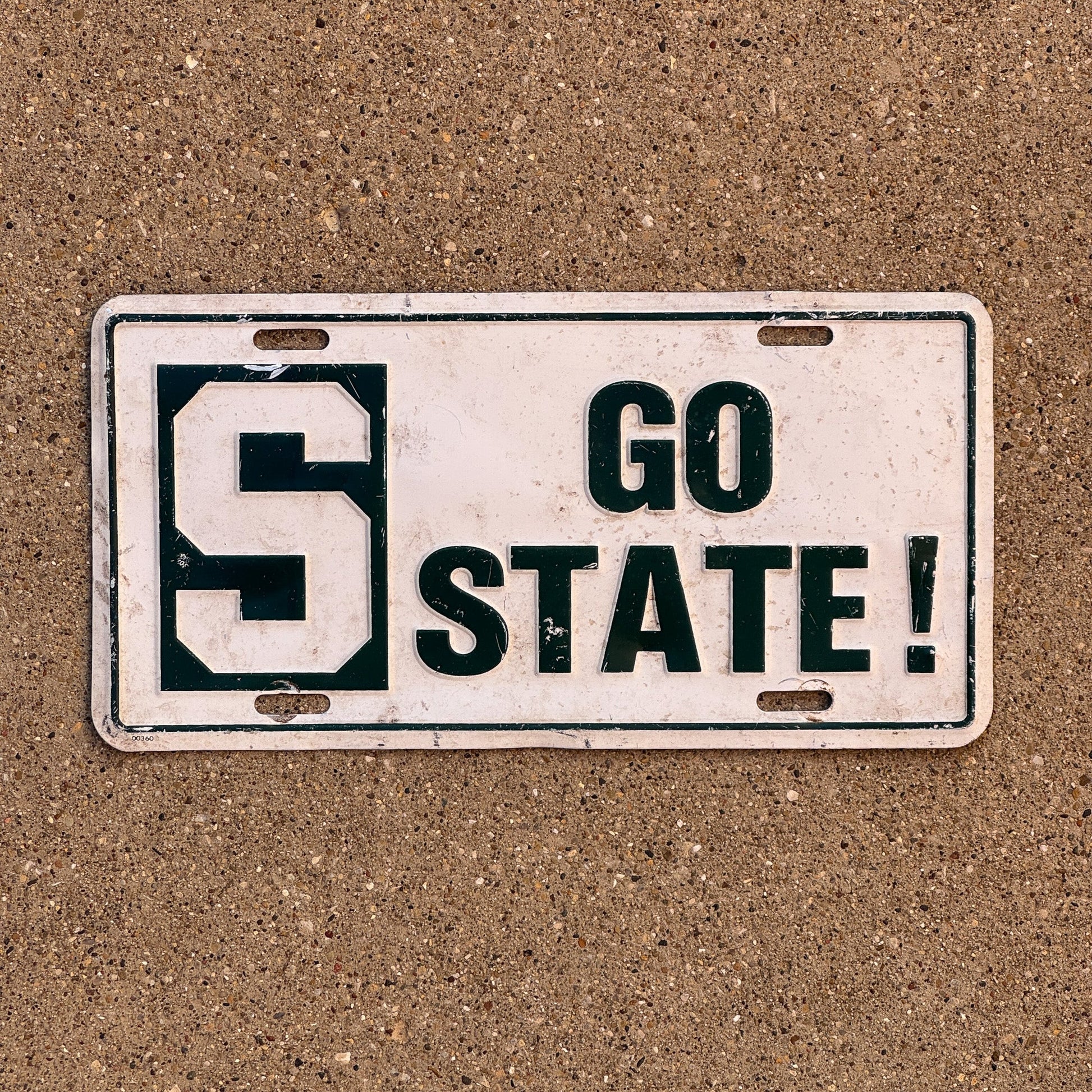Photo of a 1980 Era Michigan Booster License Plate Auto Tag Garage Decor Vintage MSU Spartans Michigan Statue University GO STATE