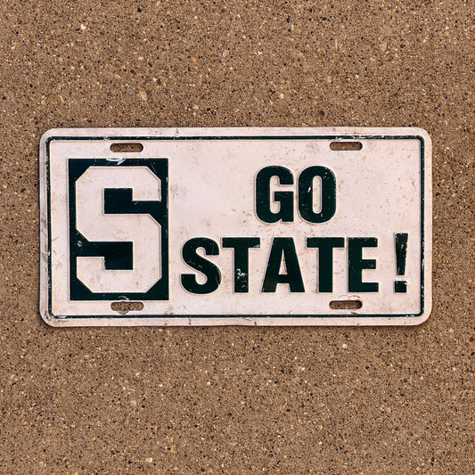 Photo of a 1980 Era Michigan Booster License Plate Auto Tag Garage Decor Vintage MSU Spartans Michigan Statue University GO STATE