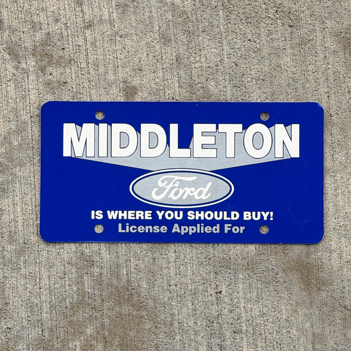 Photo of a 1980 Era Middleton Ford Booster License Plate Auto Tag Garage Decor Vintage Paper with original patina
