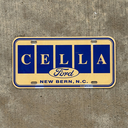 Photo of a 1980 Era New Bern North Carolina Booster License Plate Auto Tag Garage Decor Vintage Cella Ford Plastic with original patina