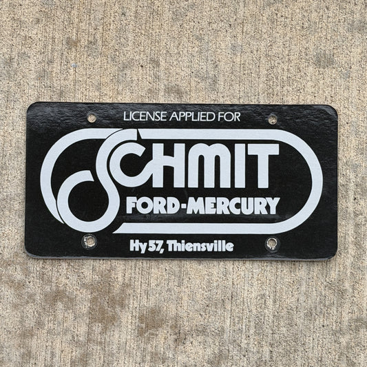 Photo of a 1980 Era Thiensville Wisconsin Booster License Plate Auto Tag Garage Decor Vintage Schmit Ford Mercury Paper with original patina