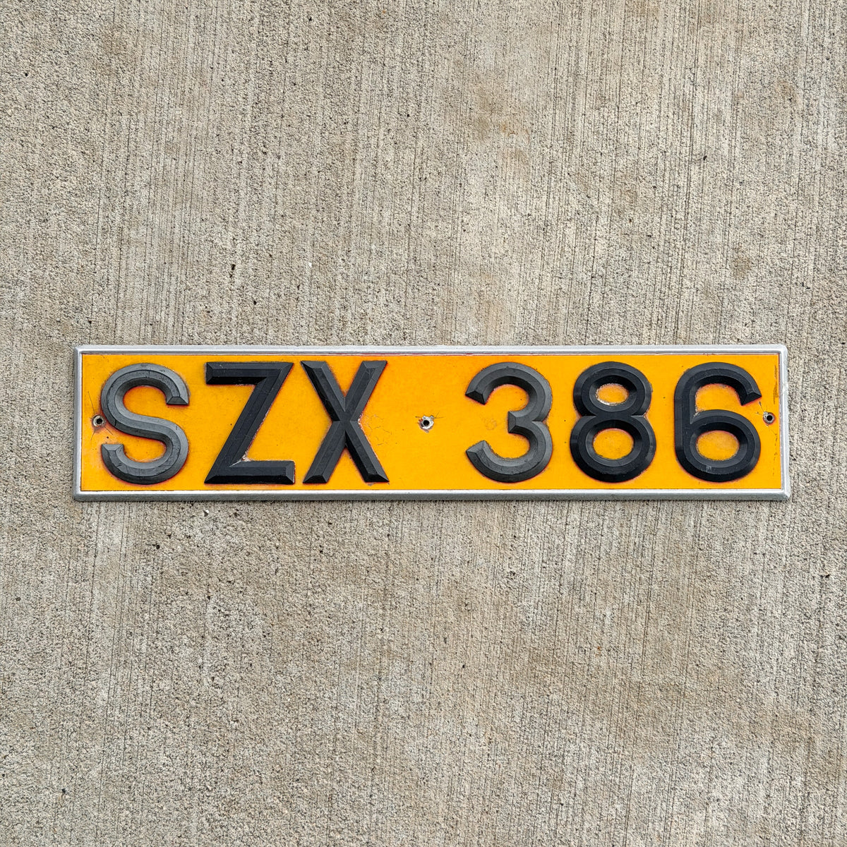 Photo of a 1980 Era United Kingdom License Plate Auto Tag Garage Decor Vintage UK England Rear Plate SZK 386 with original patina