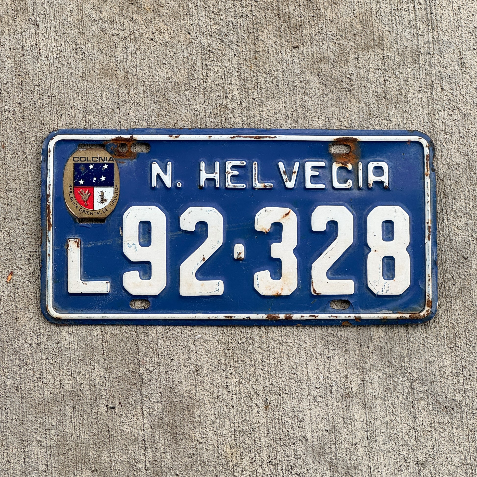 Photo of a 1980 Era Uruguay License Plate Auto Tag Garage Decor Vintage Colonia Nueva Helvecia L 92 328 with original patina
