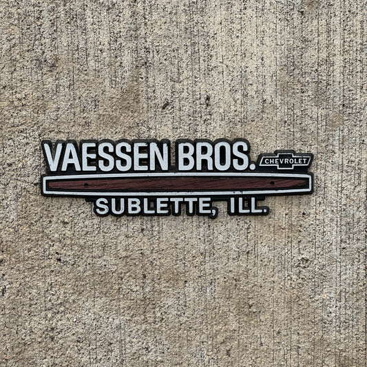 Photo of a 1980 Era Vassen Bros Sublette Illinois Dealer Badge Emblem Auto Tag Garage Decor Vintage Chevy Dealership with original patina