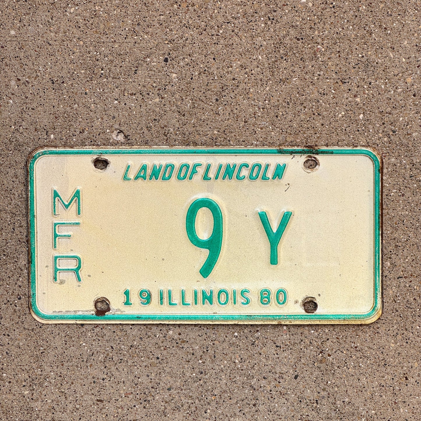 Photo of a 1980 Illinois Manufacturer License Plate Auto Tag Garage Decor Vintage 9 Y with original patina