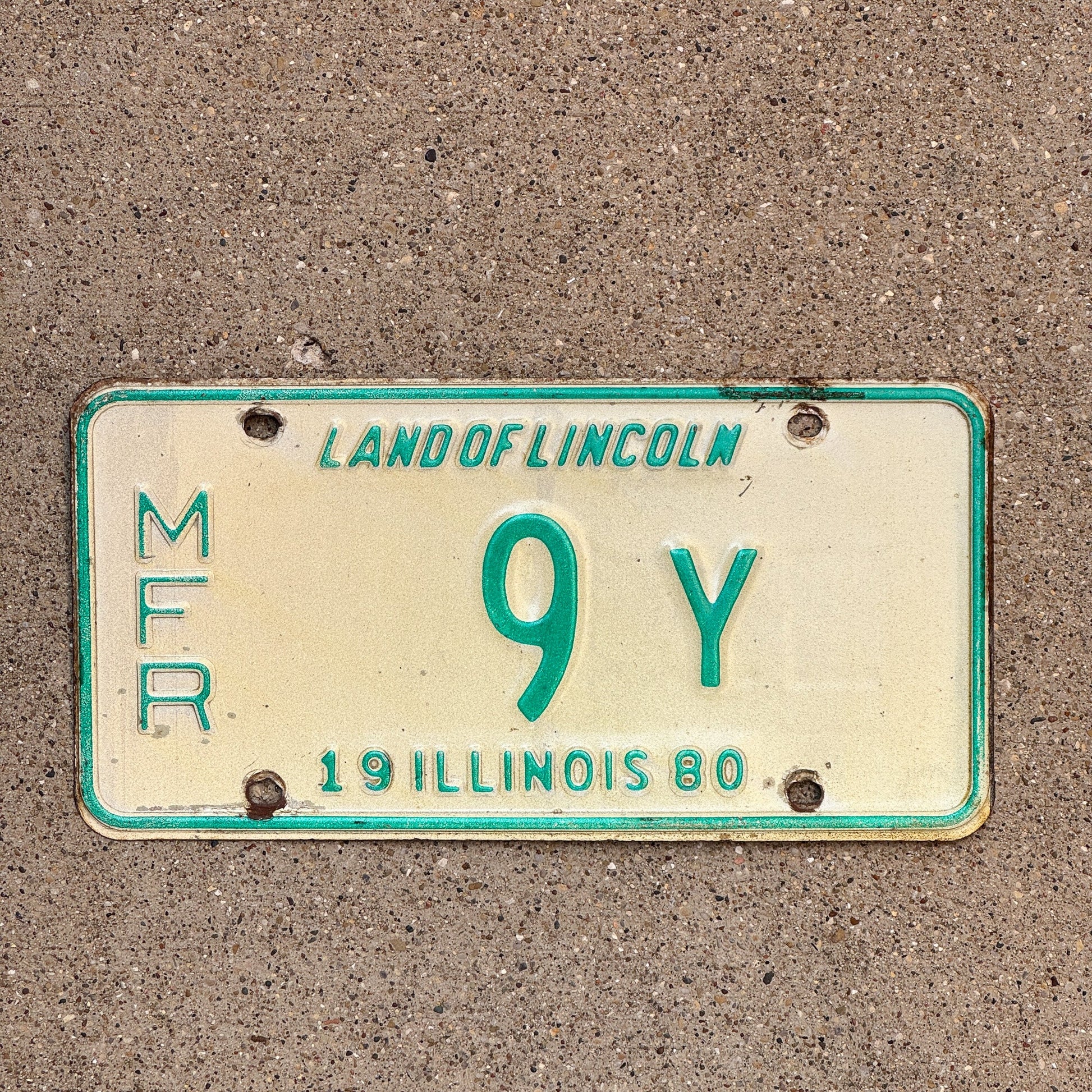 Photo of a 1980 Illinois Manufacturer License Plate Auto Tag Garage Decor Vintage 9 Y with original patina
