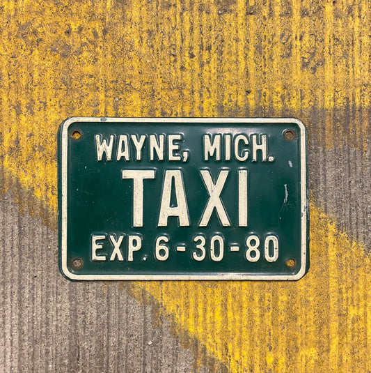 Photo of a 1980 Michigan Taxi License Plate Auto Tag Garage Decor Vintage Small Size Wayne with original patina