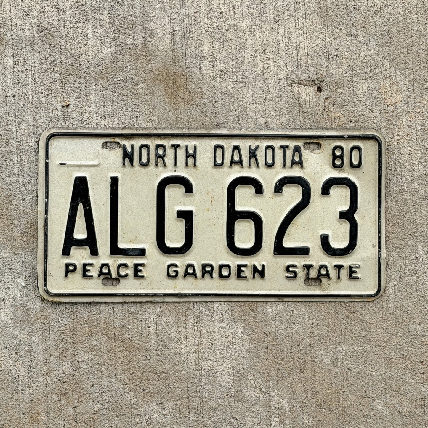Photo of a 1980 North Dakota License Plate Auto Tag Garage Decor Vintage ALG 623 with original patina